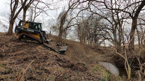 skid steer clearing woods